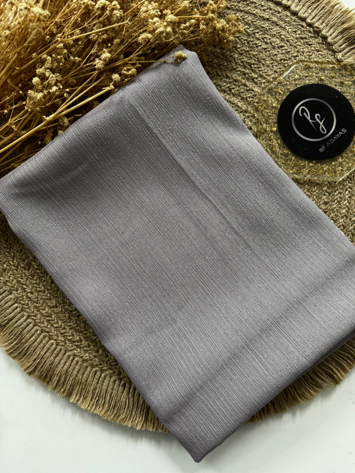Shimmering metallic silk hijab by RF Abayas featuring a luxurious, shiny fabric with a smooth, flowing drape.