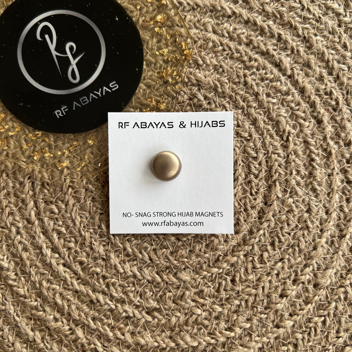 Pair of RF Abayas round matte black hijab magnets, magnetic pins for securing hijabs with a sleek, discreet design.
