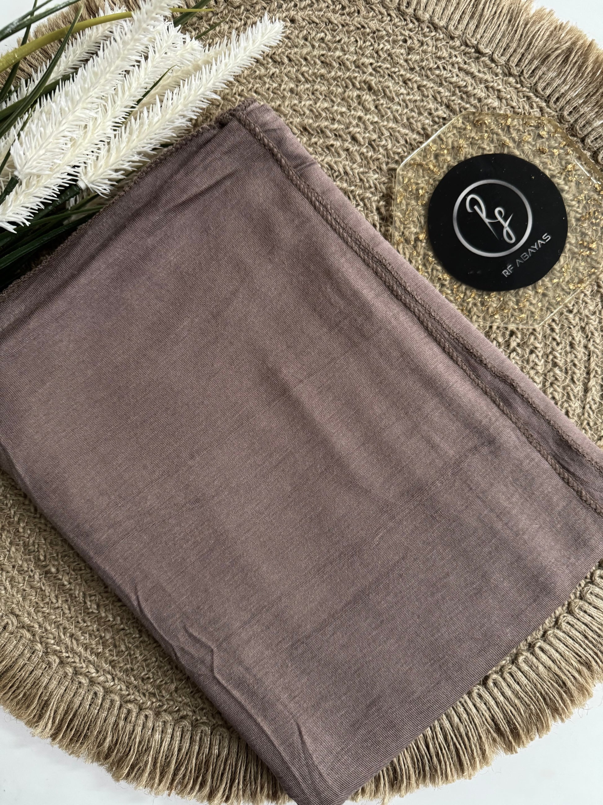 RF Abayas bamboo jersey hijab in a soft, natural fabric with a smooth texture, draped elegantly on a plain background.