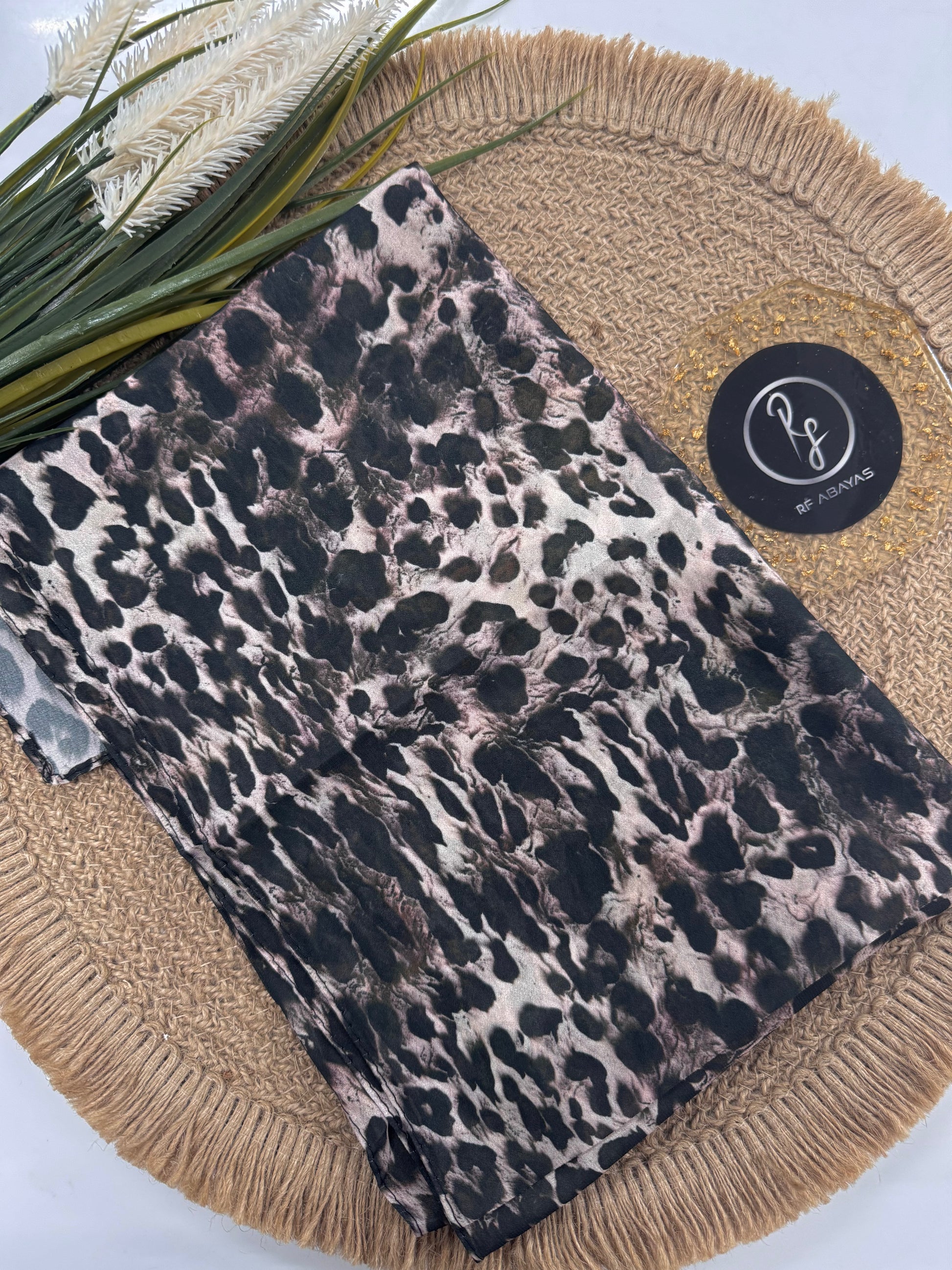 RF Abayas animal print chiffon hijab draped elegantly, showcasing soft, lightweight fabric with stylish leopard pattern.