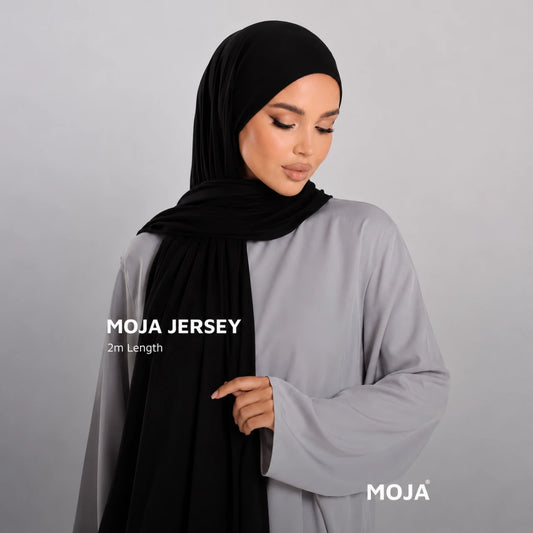 Woman wearing a black Moja bamboo jersey hijab, 2 m length, over a grey abaya – RF Abayas & Hijabs