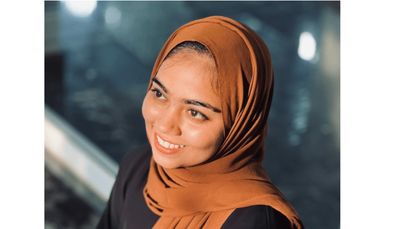 Woman wearing a brown georgette hijab with a blurred background