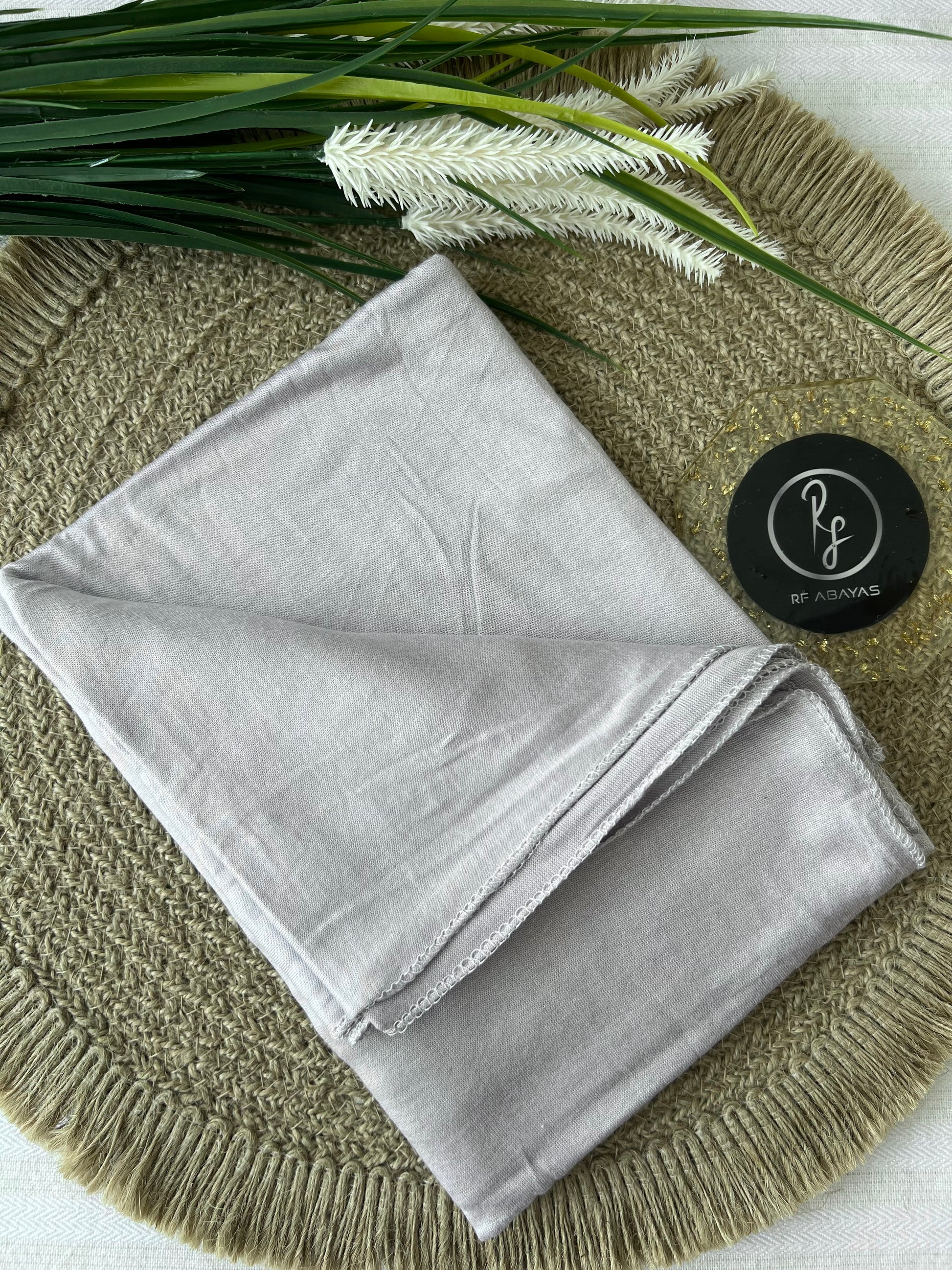 Ivory bamboo jersey hijab by RF Abayas, soft and lightweight fabric, draped smoothly to showcase its elegant texture.